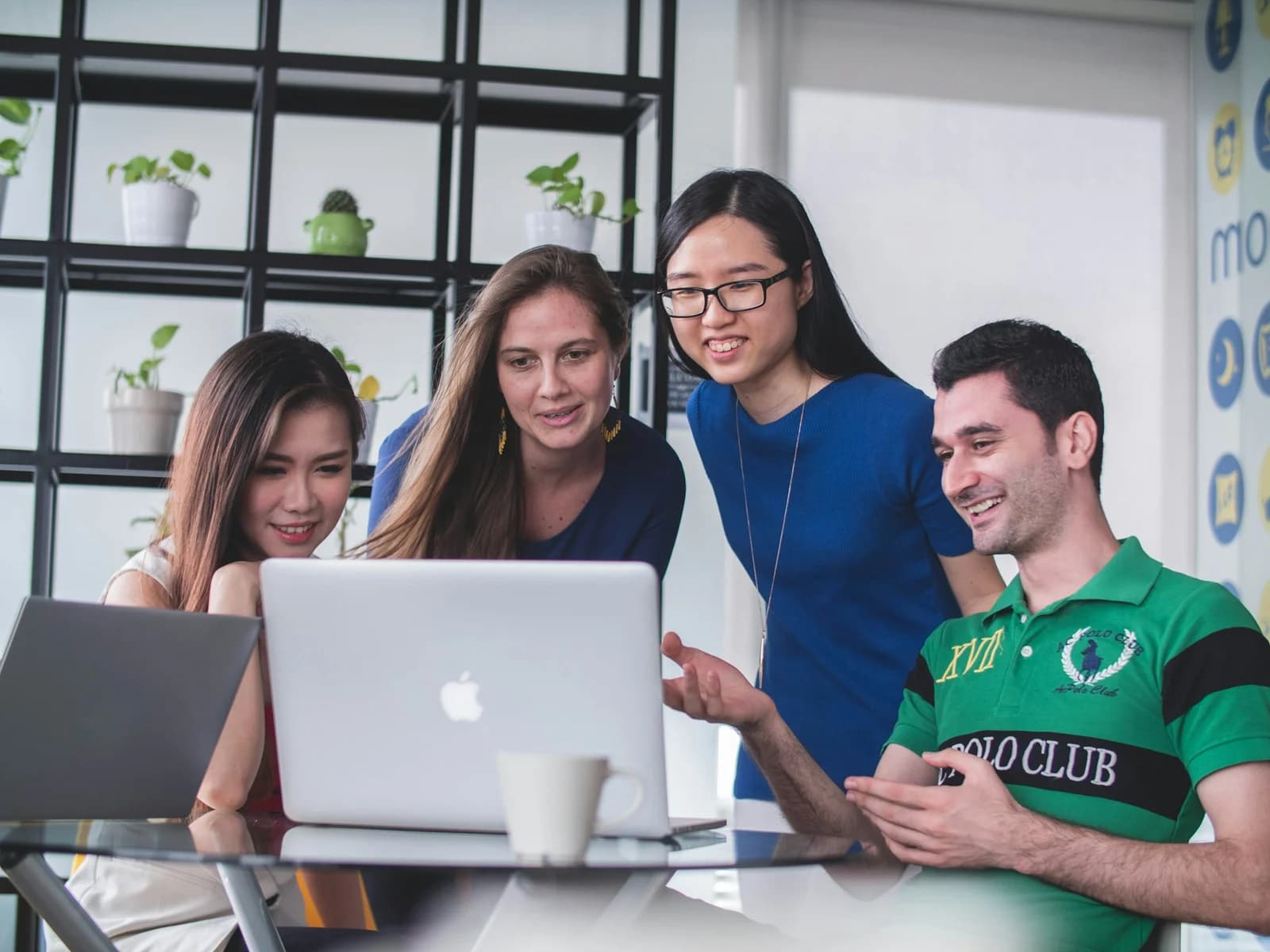 People collaborating around laptops